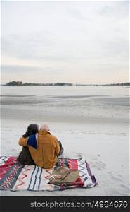 Mature couple sitting on the beach