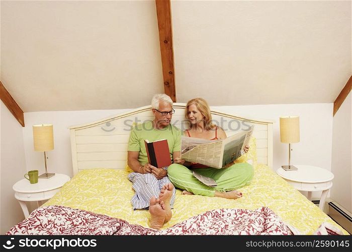 Mature couple sitting on the bed