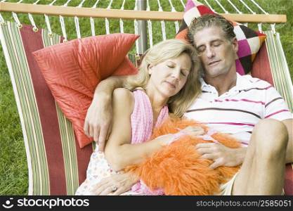 Mature couple sleeping in a hammock