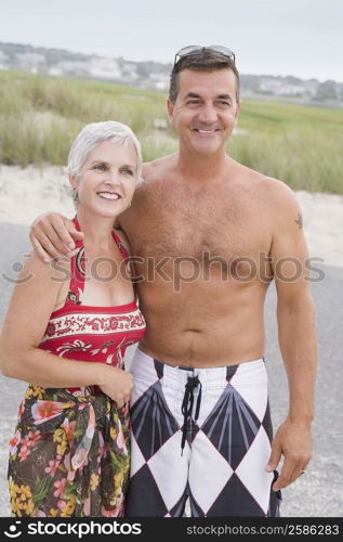 Mature couple smiling with arm around