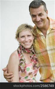 Mature couple smiling with arm around