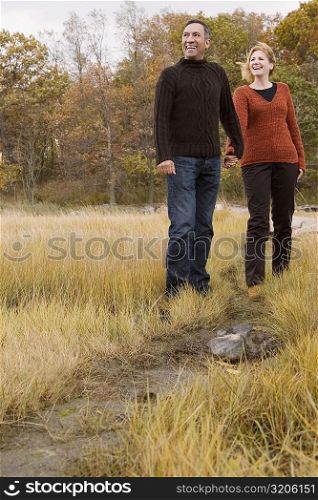 Mature couple smiling with holding each other hands