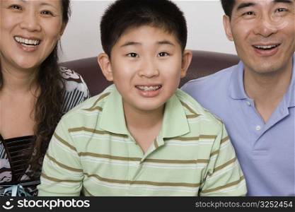 Mature couple smiling with their son
