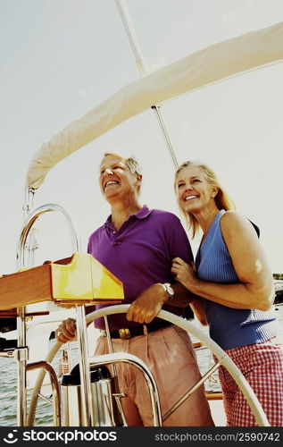 Mature couple standing in a boat and smiling