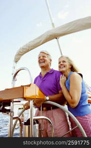 Mature couple standing in a boat and smiling