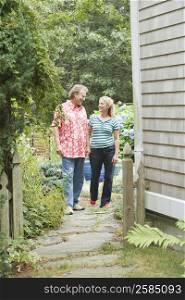 Mature couple standing in a garden and looking at each other