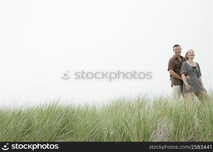 Mature couple standing in a grassy field