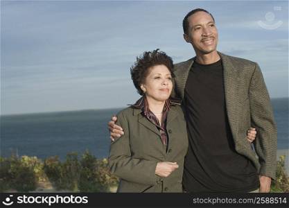 Mature couple standing on the beach