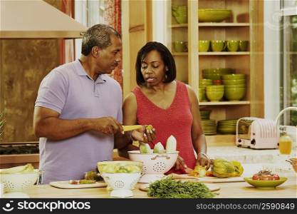 Mature couple talking in the kitchen