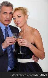 Mature couple toasting with champagne
