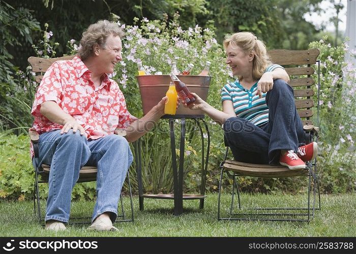 Mature couple toasting with drinks