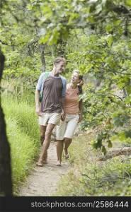 Mature couple walking in a forest and looking at each other