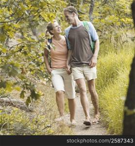Mature couple walking in a forest with holding hands