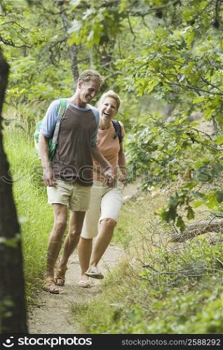 Mature couple walking in a forest with holding hands