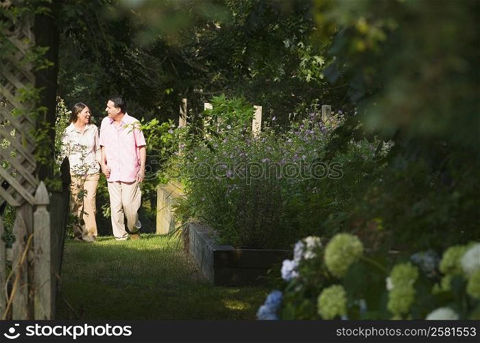 Mature couple walking in a garden