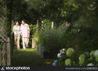 Mature couple walking in a garden