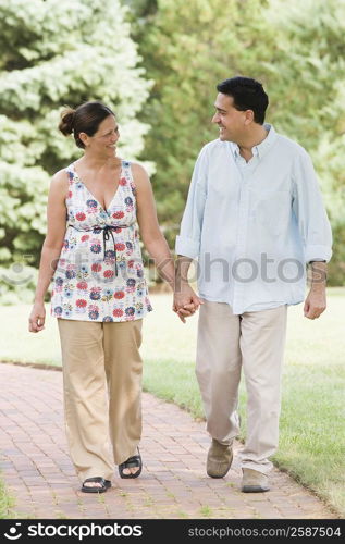 Mature couple walking in the park and smiling