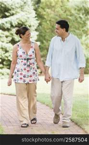 Mature couple walking in the park and smiling