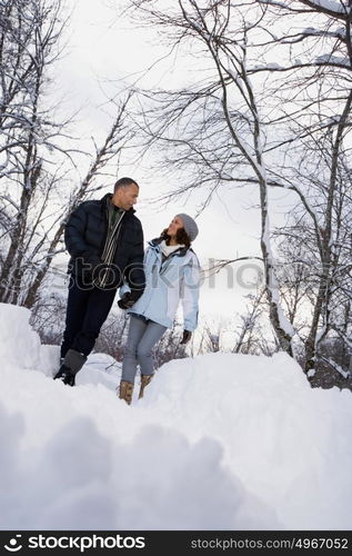 Mature couple walking through snow