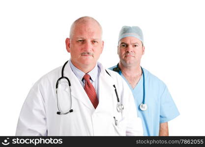 Mature doctor and younger, surgical intern. Medical team with serious expressions. Isolated on white.