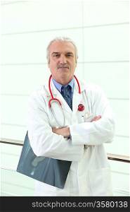 mature doctor crossing arms