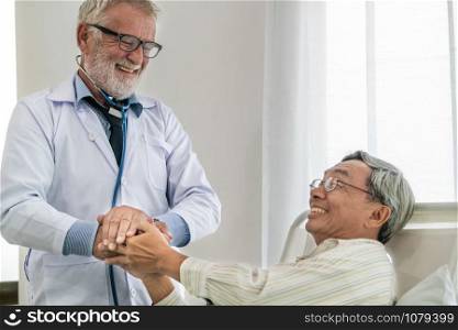 Mature doctor talking and examining health of senior patient in hospital ward. Medical healthcare and doctor staff service concept.