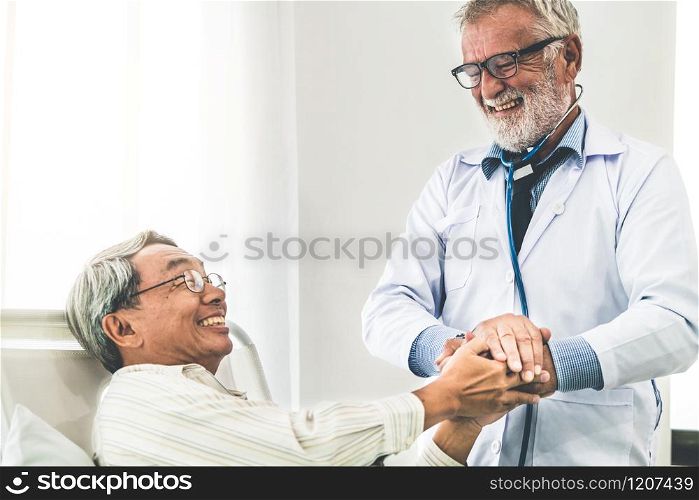 Mature doctor talking and examining health of senior patient in hospital ward. Medical healthcare and doctor staff service concept.. Mature doctor and senior patient in hospital ward.