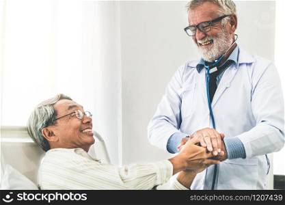 Mature doctor talking and examining health of senior patient in hospital ward. Medical healthcare and doctor staff service concept.. Mature doctor and senior patient in hospital ward.