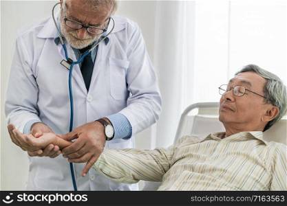 Mature doctor talking and examining health of senior patient in hospital ward. Medical healthcare and doctor staff service concept.