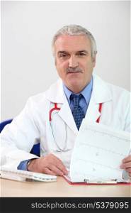 Mature doctor with clipboard