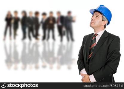 Mature engineer with blue hat looking up