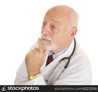 Mature, experienced doctor lost in thought. Isolated on white.