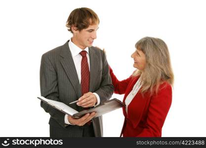 Mature female boss congratulating her young male employee on a job well done. Isolated on white.