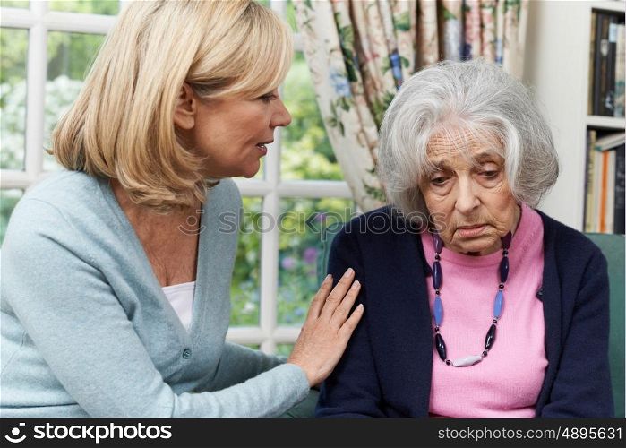 Mature Female Friend Comforting Unhappy Senior Woman