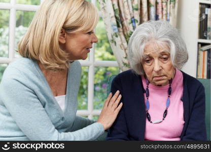 Mature Female Friend Comforting Unhappy Senior Woman