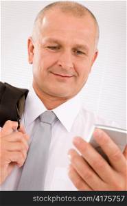 Mature handsome businessman wear suit looking at phone close-up portrait