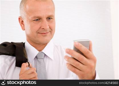 Mature handsome businessman wear suit looking at phone close-up portrait