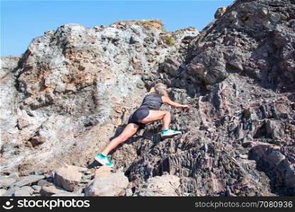 Mature healthty woman exercising rock climbing