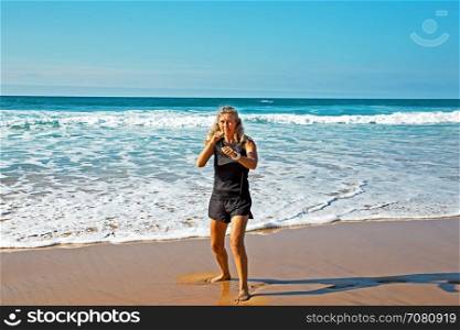 Mature healthty woman exercising shadow boxing