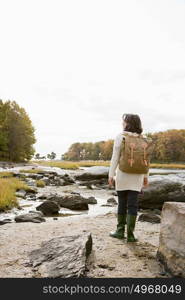 Mature hiker walking over rocks