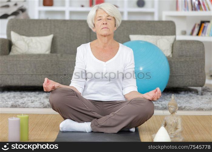 mature lady doing yoga at home