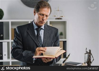 mature lawyer turning pages law book courtroom