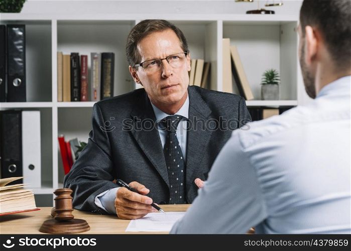 mature lawyer with clients meeting