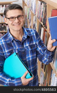 Mature Male Student Studying In Library