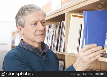 Mature Male Student Studying In Library