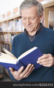 Mature Male Student Studying In Library