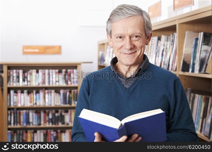 Mature Male Student Studying In Library