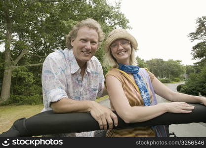 Mature man and a mid adult woman in a convertible car and smiling