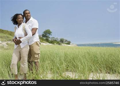 Mature man and a mid adult woman romancing on the beach