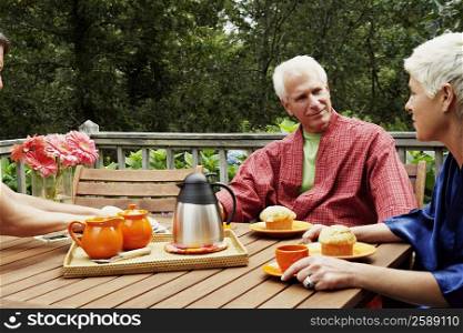 Mature man and a senior woman sitting at the table and looking at each other